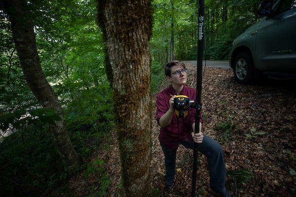 A researcher uses GPS in Alabama forest land.