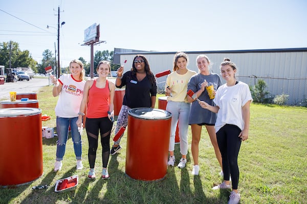 Honors students participate in a service project to paint a local business.