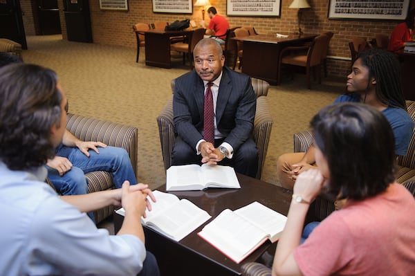 Law students discuss course material with a faculty member